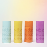 Load image into Gallery viewer, 4 colorful canisters of NӦZ sunscreen for the nose each in light blue, yellow, orange, and purple 
